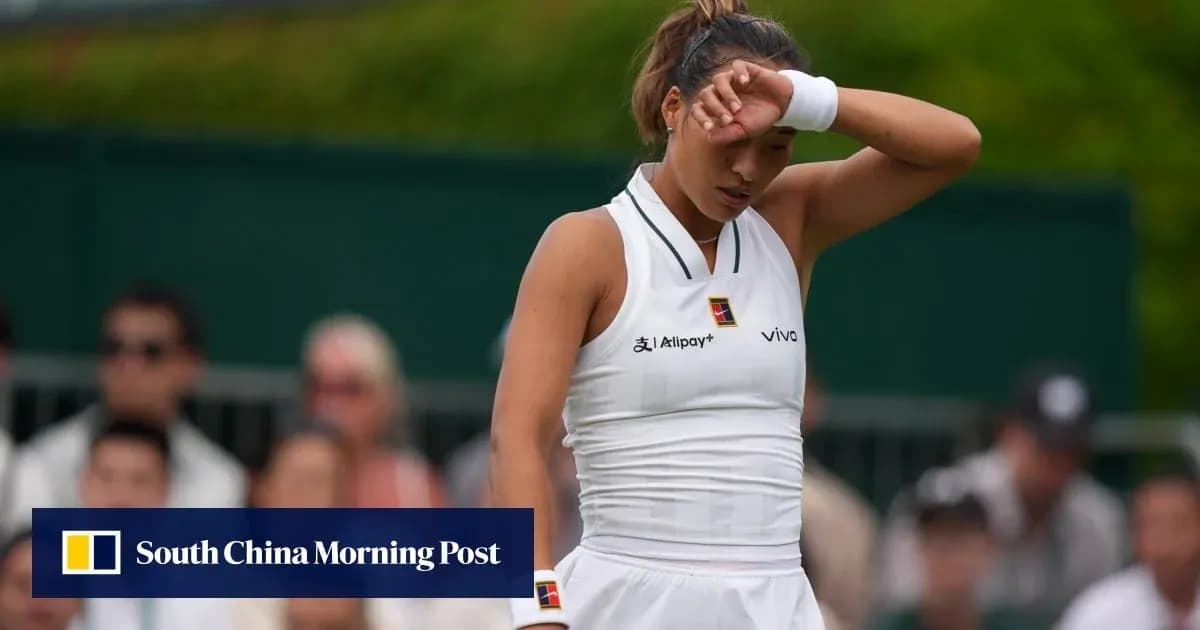 Tennis player wiping forehead during match