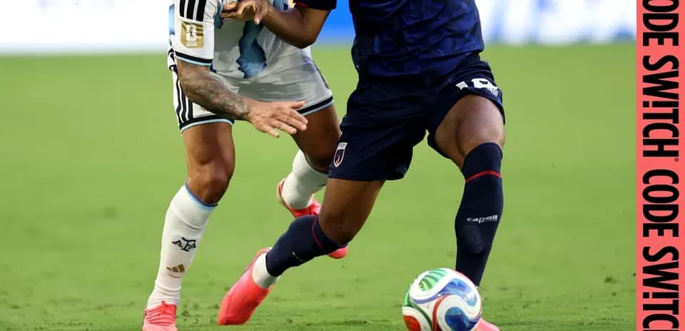 Two players battling for the ball on field
