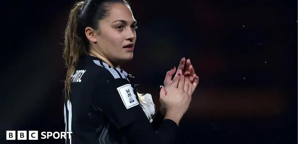 Goalkeeper applauding after match in black kit