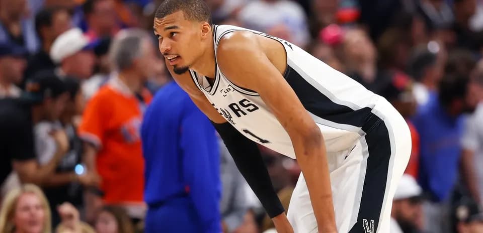 Basketball player bending over during a game