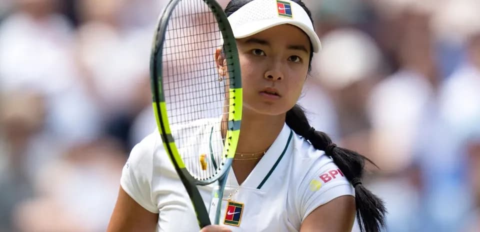 Tennis player preparing to serve during match