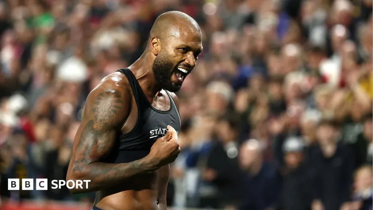 Athlete celebrating in front of cheering crowd