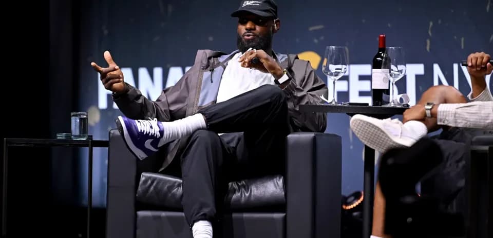 Speaker gesturing during a panel discussion on stage