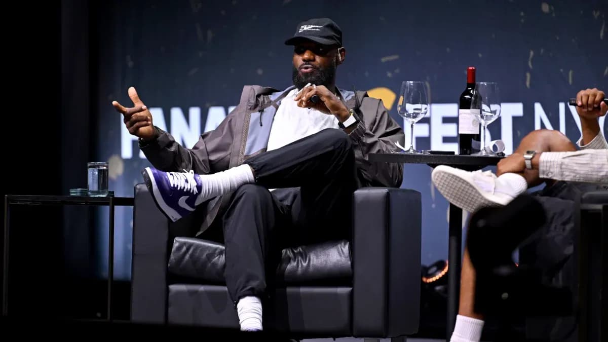 Speaker gesturing during a panel discussion on stage