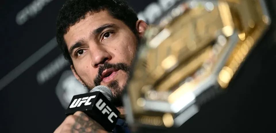 UFC fighter speaking at press conference with championship belt