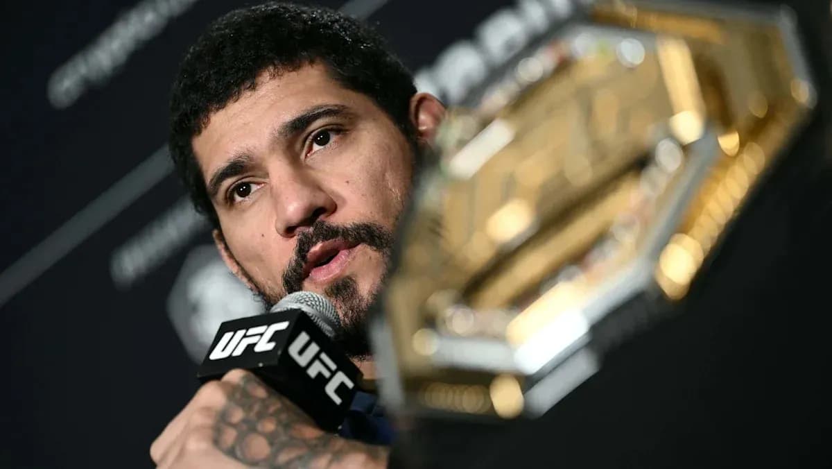 UFC fighter speaking at press conference with championship belt