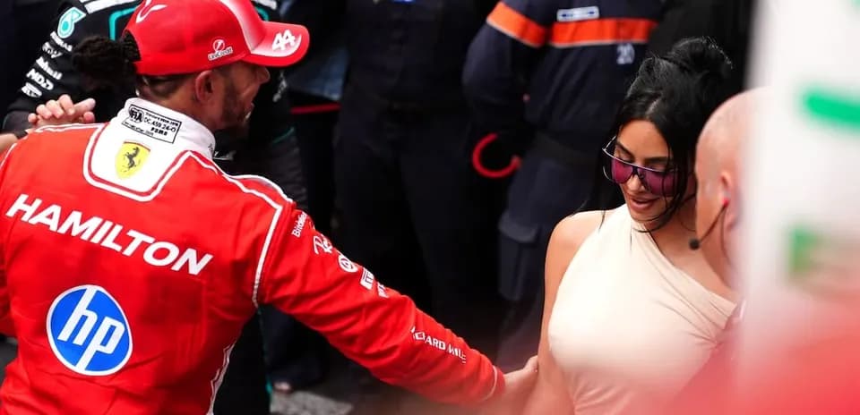Formula 1 driver greeting a woman in paddock