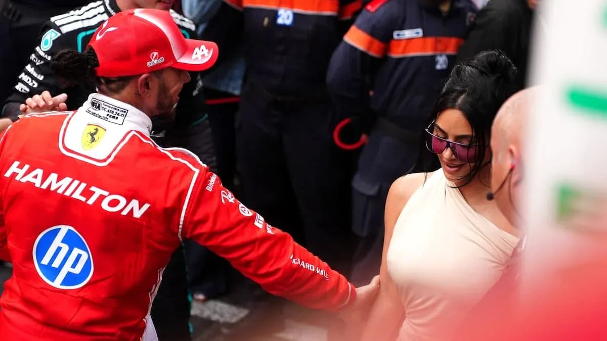 Formula 1 driver greeting a woman in paddock