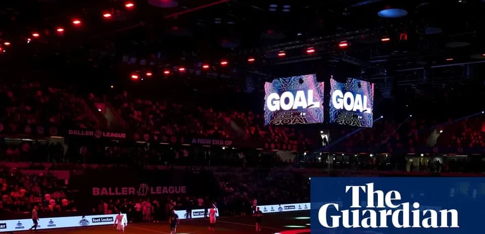 Stadium lights and screens displaying 'GOAL' during match