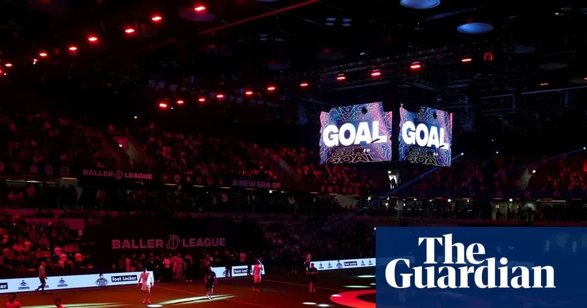 Stadium lights and screens displaying 'GOAL' during match
