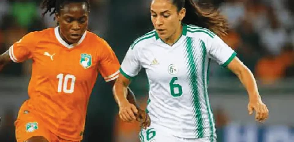 Two female players competing for the ball