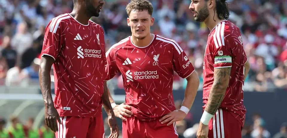 Liverpool players discussing strategy during match
