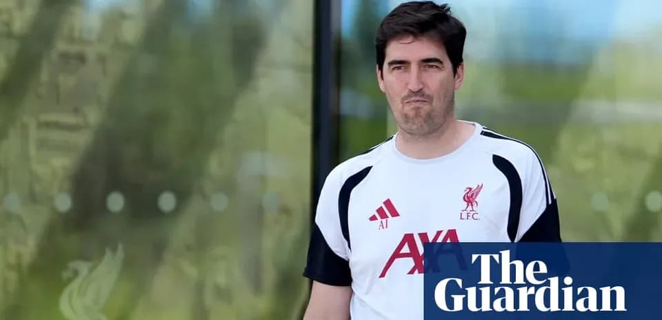 Man in Liverpool training kit walking outside facility