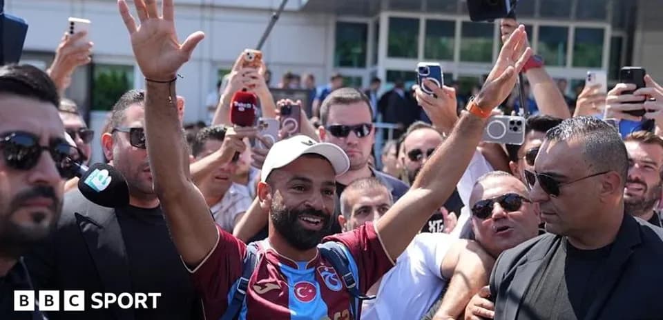 Fan celebrating with crowd outside stadium