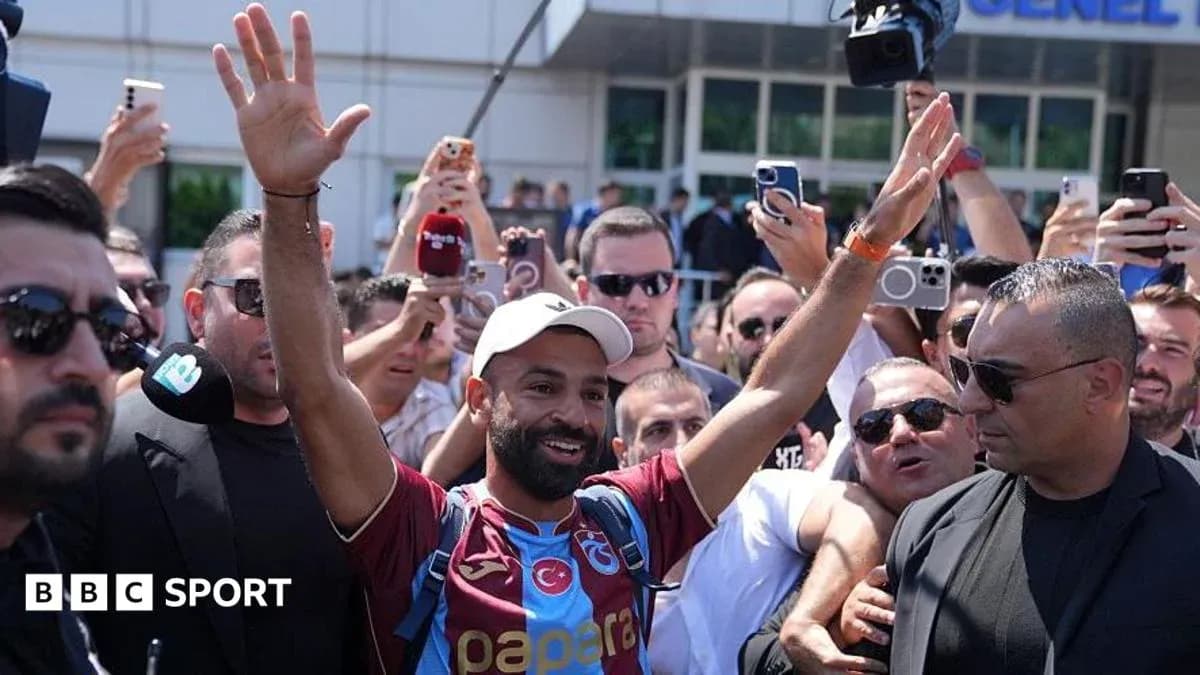 Fan celebrating with crowd outside stadium