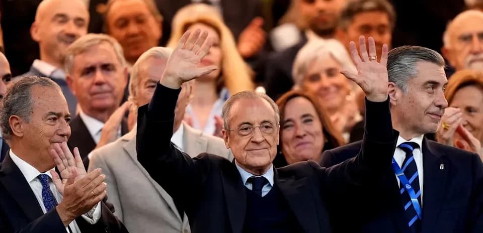 People applauding at an event, with one man waving
