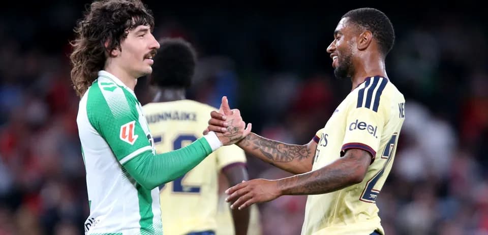 Two football players shaking hands after match