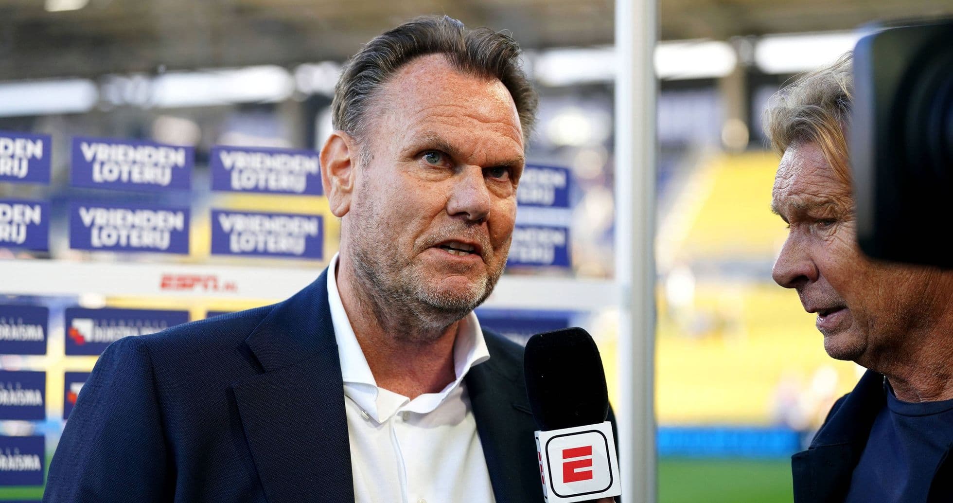 Interviewer speaking with coach during pre-match interview