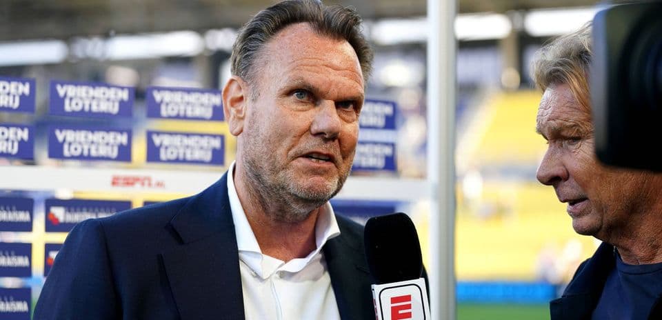 Interviewer speaking with coach during pre-match interview