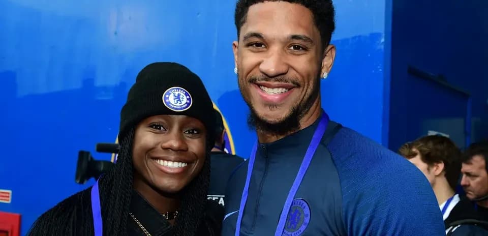 Two people posing together in Chelsea apparel