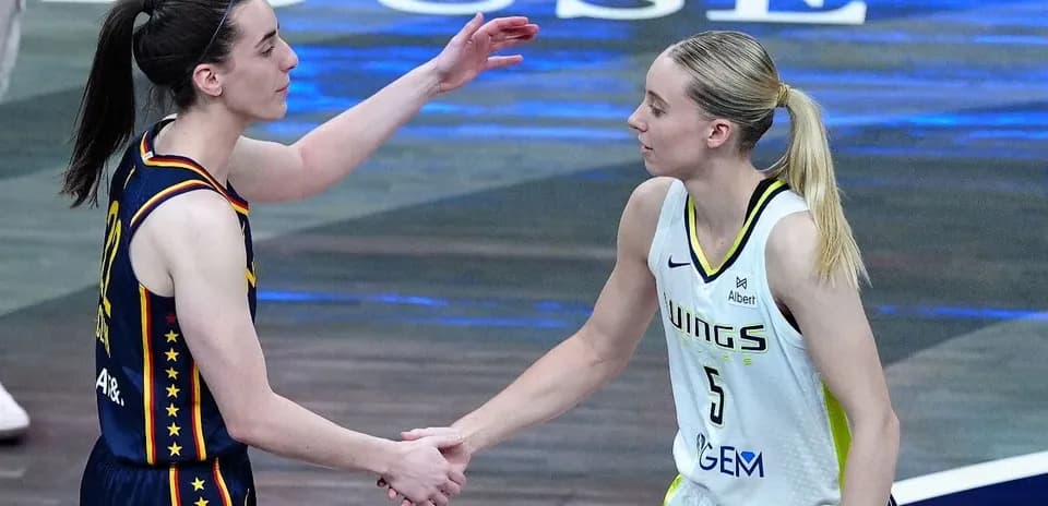 Two basketball players shaking hands after a game