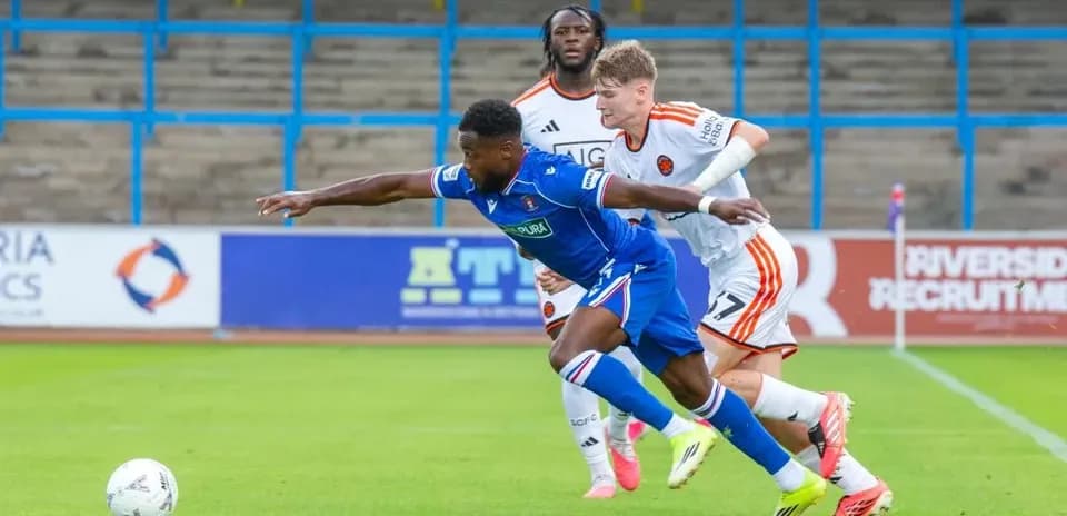 Player attempting to control the ball while tackled