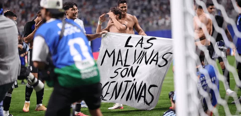 Players celebrating with a banner on the field
