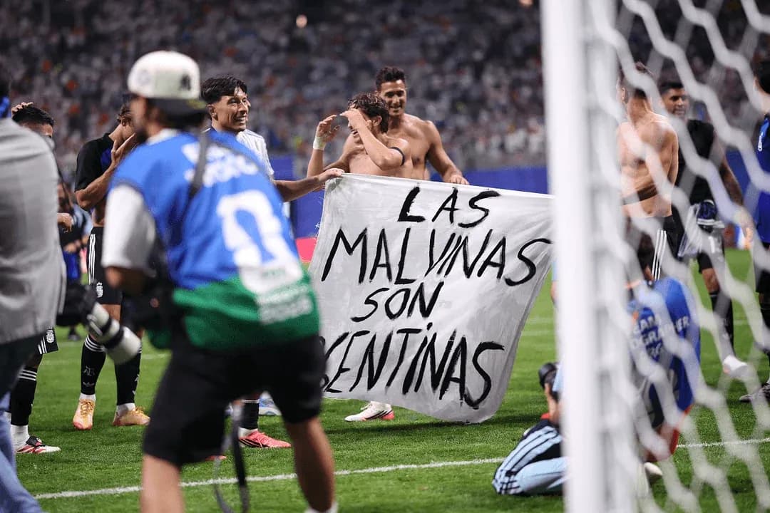 Players celebrating with a banner on the field