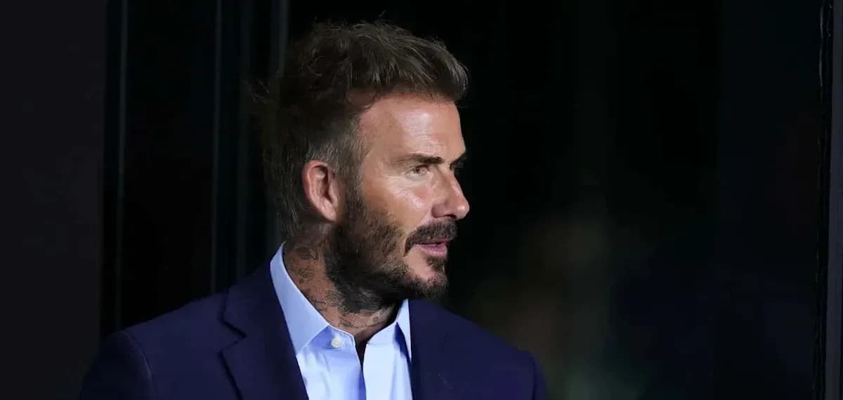 Man in suit with tattoos speaking at event