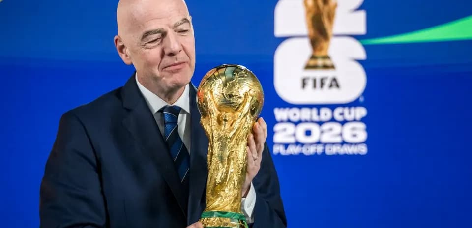 FIFA president holding World Cup trophy at event