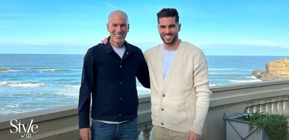 Two men posing by the seaside with ocean view