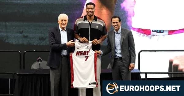 Giannis holding Miami Heat jersey with team officials