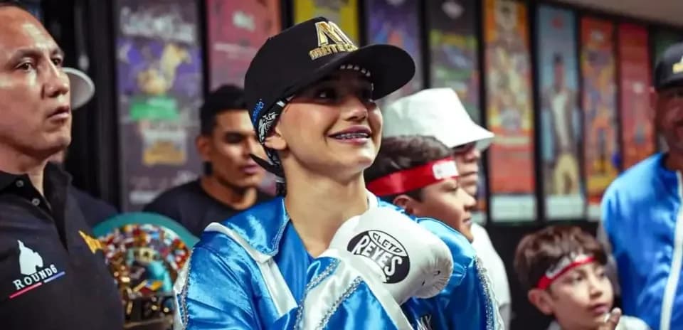 Boxer smiling while wearing gloves and cap