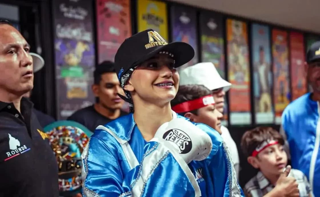 Boxer smiling while wearing gloves and cap