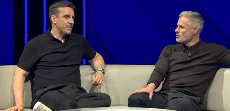Analysts discussing on a sofa during broadcast