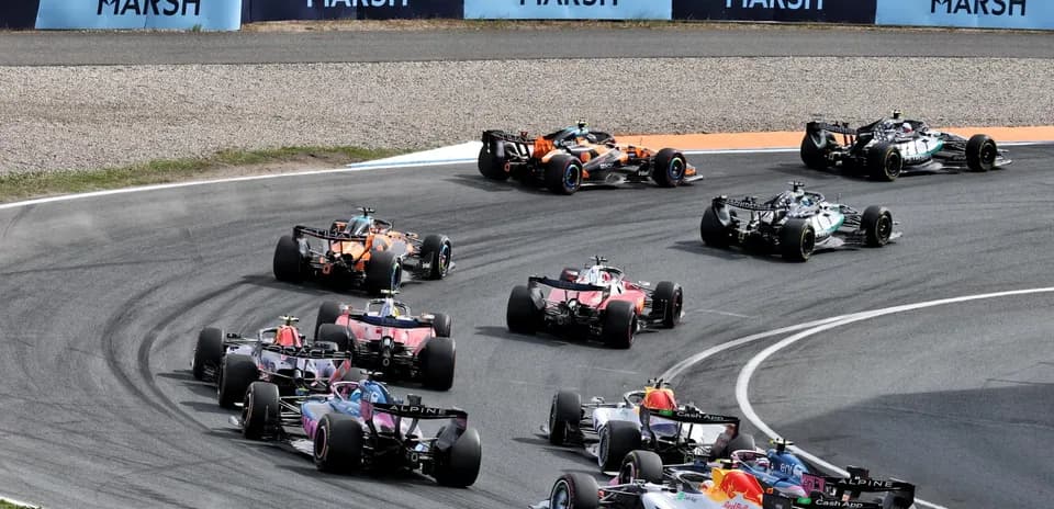 Formula 1 cars racing on a curved track