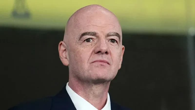 FIFA president attending an event, looking serious
