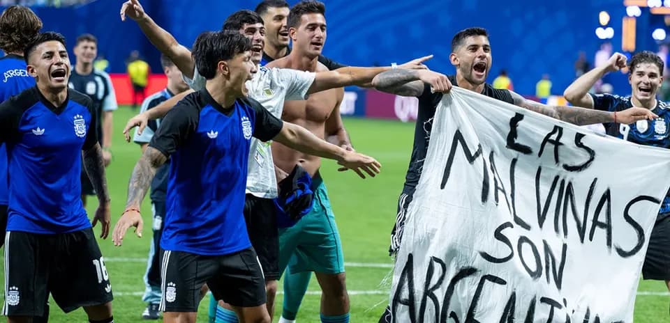 Argentina players celebrating with a banner after match