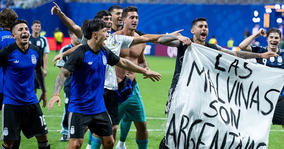 Argentina players celebrating with a banner after match