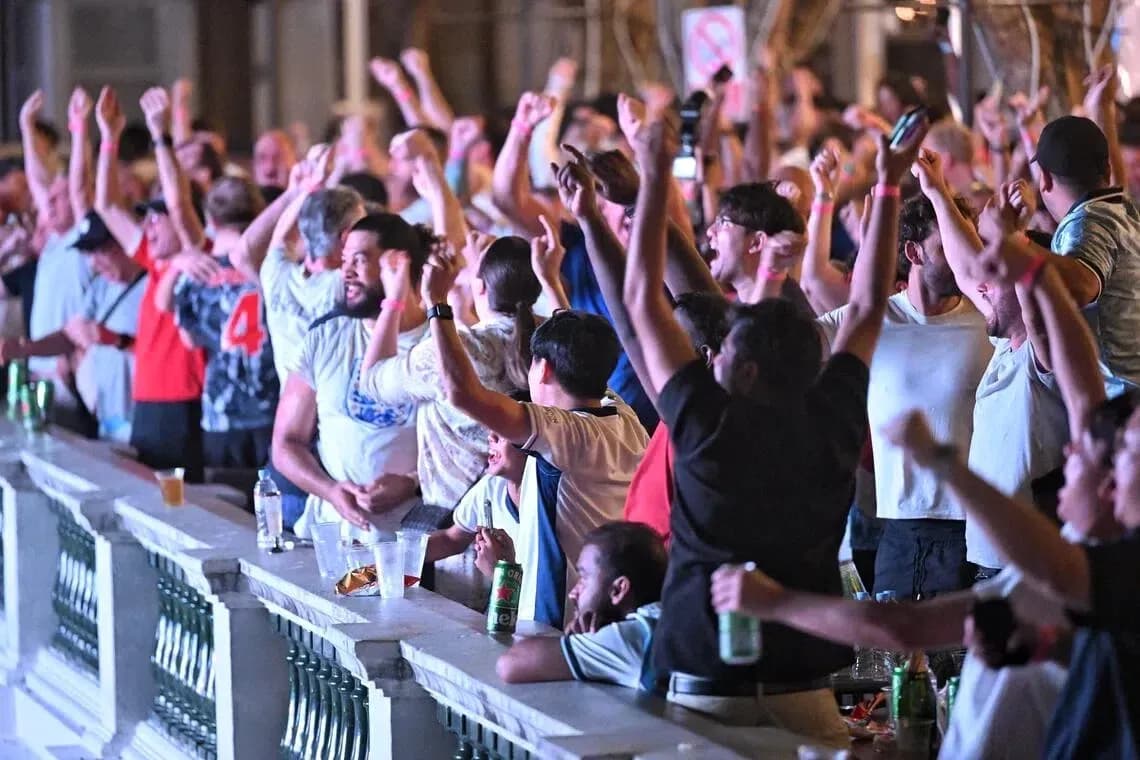 Fans celebrating at a sports viewing event