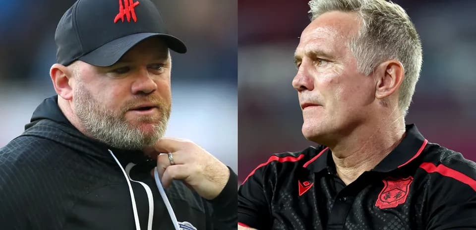 Two football managers discussing during match
