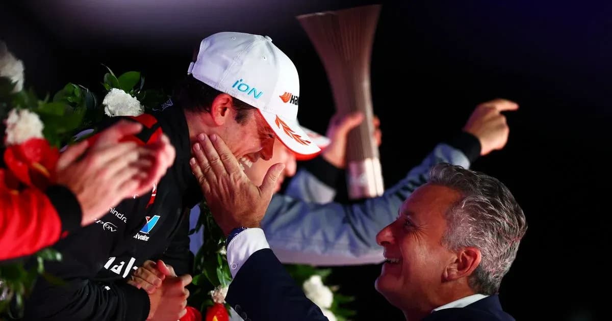 Driver celebrating victory on podium with trophy