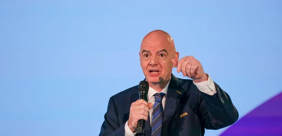 FIFA official speaking at a podium event