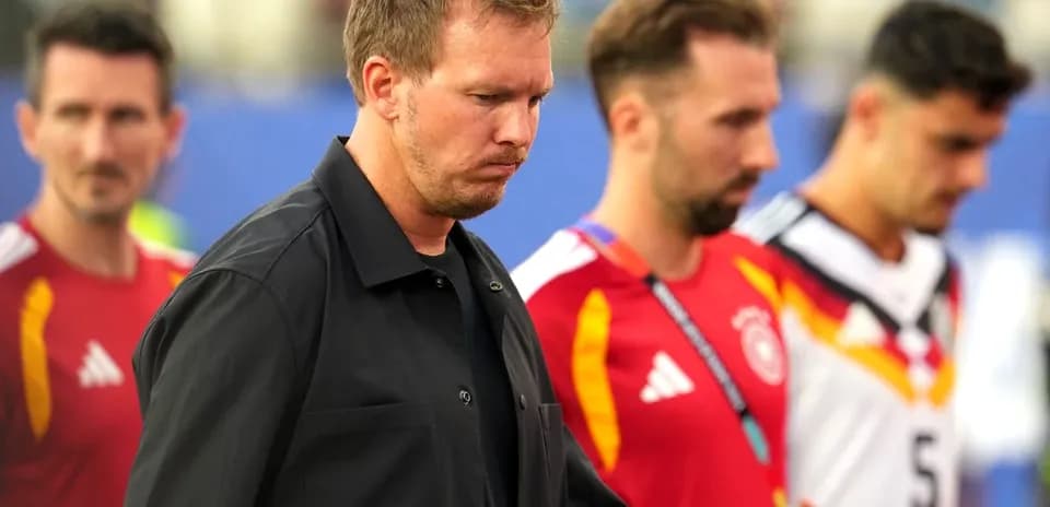 Trainers and players walking off the pitch