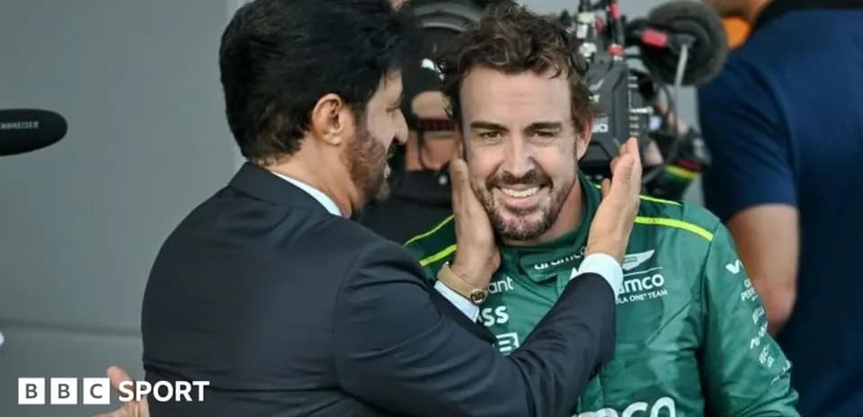 Fernando Alonso celebrating with team member after race
