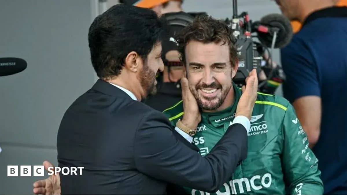 Fernando Alonso celebrating with team member after race