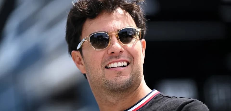 Formula 1 driver wearing sunglasses outdoors