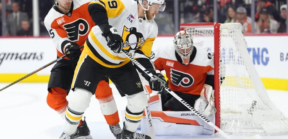 Hockey players battling for puck near goal