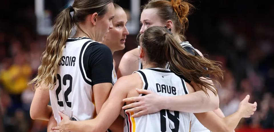 Basketball players celebrating in a huddle