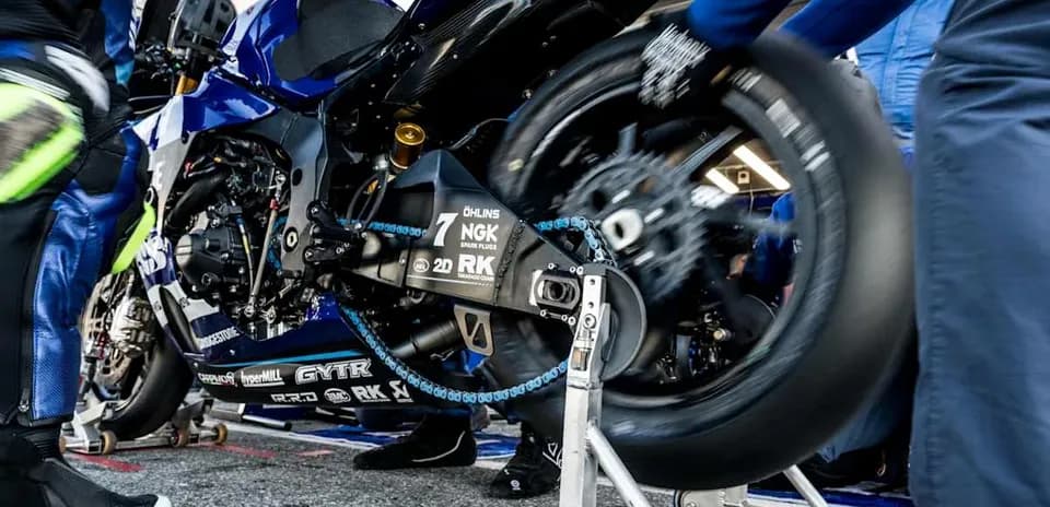 MotoGP team working on motorcycle in pit area
